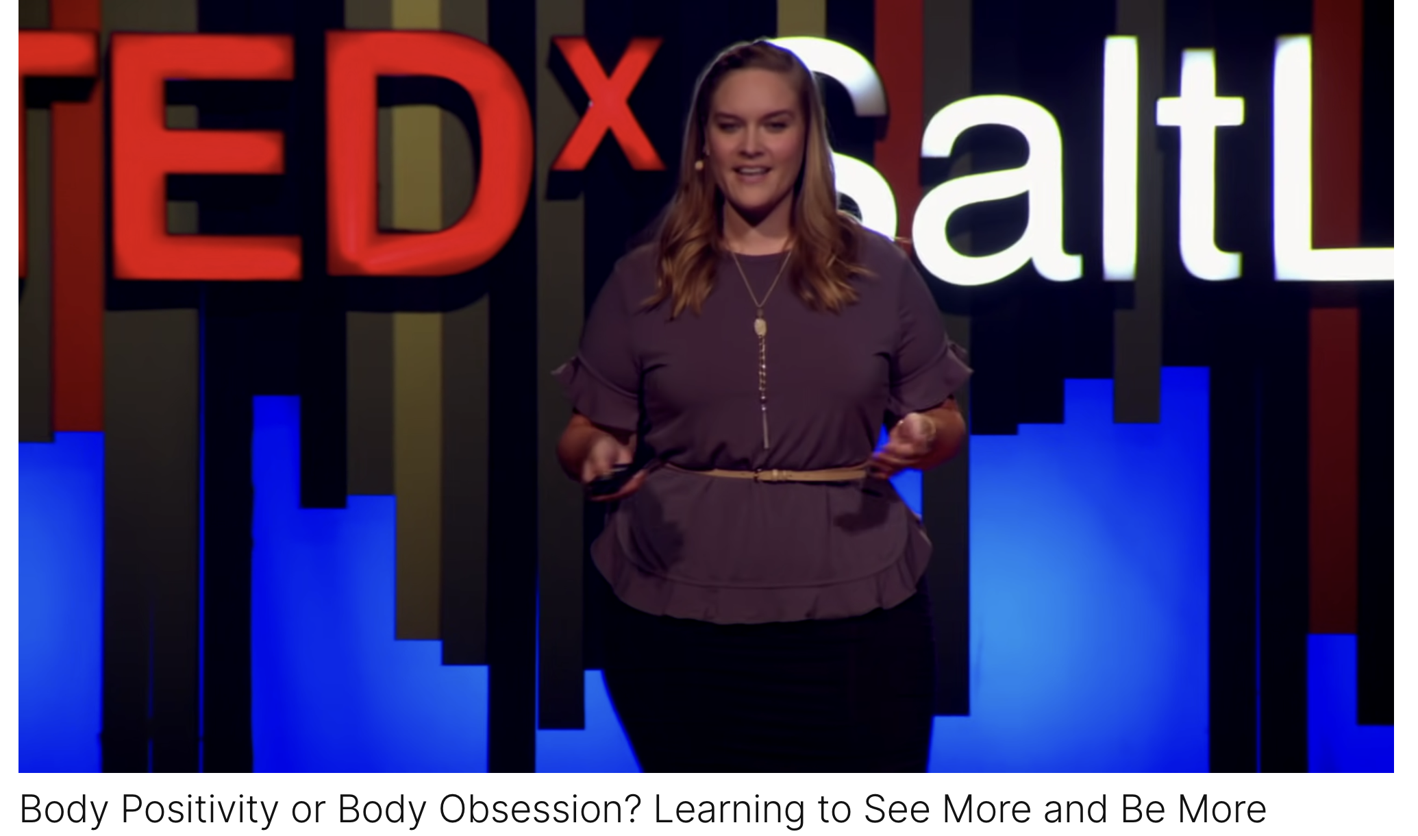 TedX woman speaker with blond hair standing in front of a TedX backdrop