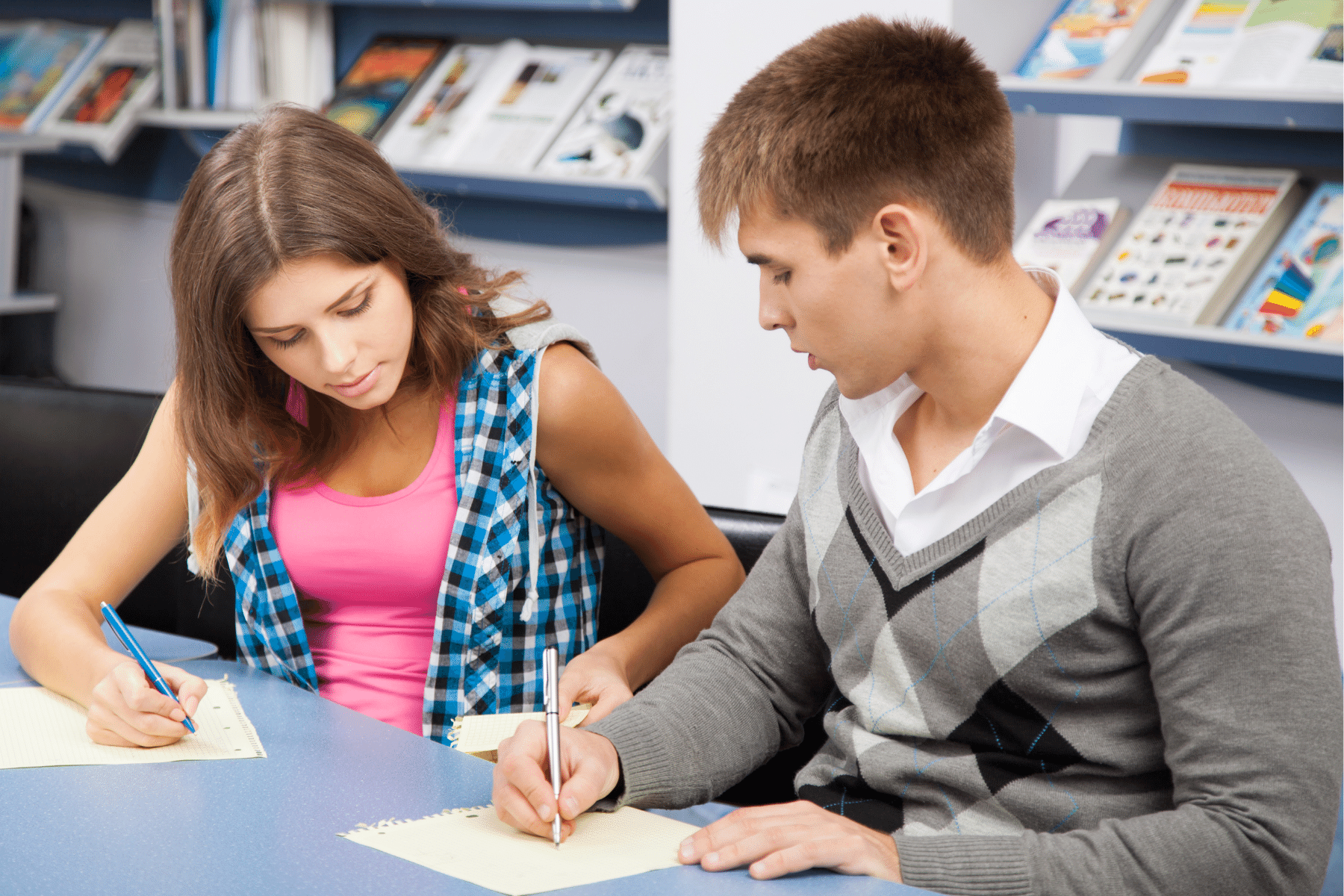 drawing of a person taking an exam while looking at their lap that has notes written on them